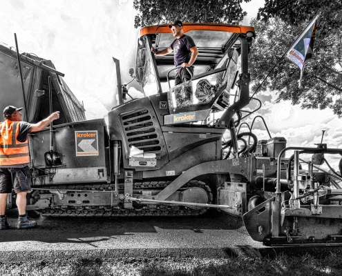 Baustellenimpression während Straßenbauarbeiten bei Apelnstedt im Landkreis Wolfenbüttel mit Asphaltmaschine, Vorarbeiter und Maschinenführer.